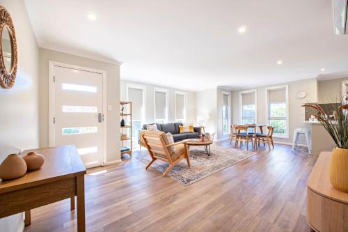 a living room with a couch and a table at Lilly Pilly Lodge - Close to Zoo, 3 Mins to CBD in Dubbo