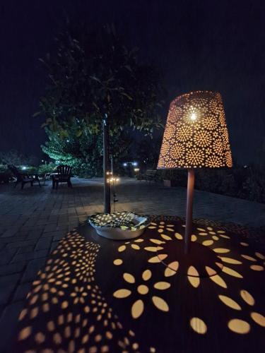 a lamp sitting on a patio at night at B&B La Terrazza Degli Scrittori in Racalmuto