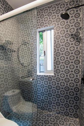 a bathroom with a shower with a toilet and a window at ¡Buen Alma! House in heart of Condesa 8 guests in Mexico City