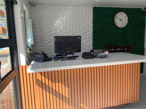 a counter with a clock on the wall and a clock at Hotel Guillen in Tijuana