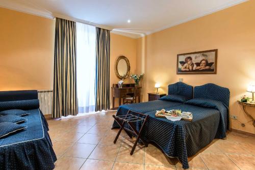 a living room with a couch and a table at Hotel Caracciolo in Rome