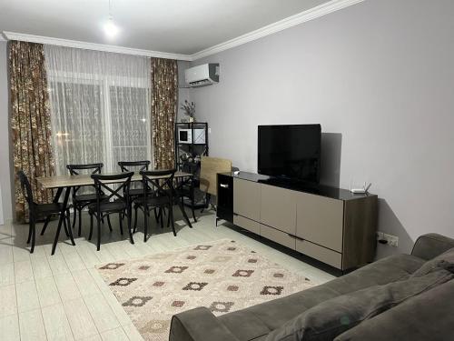 a living room with a couch and a table and chairs at Royal Sun in Iskele