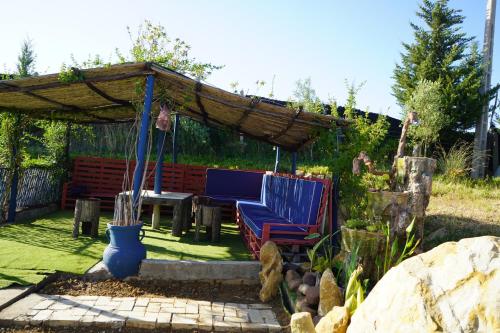 a patio with a blue bench and a pergola at jnan Lemonie in Asilah