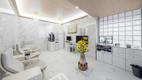 a kitchen with a vase of flowers on a table at Breaktime Hotel in Pohang