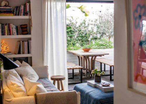 a living room with a couch and a table at The Artist Retreat 2BR Home 4mins from MCG in Melbourne