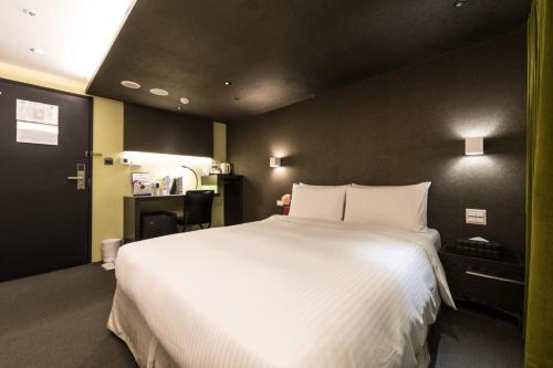 a bedroom with a large white bed in it at 凡登台北商務旅店 in Taipei