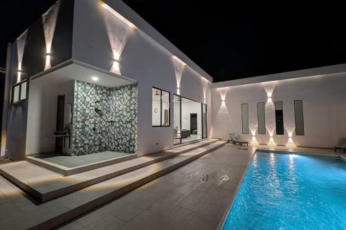 a swimming pool in the middle of a house at The Refuge Your Oasis in Nilo in Nilo