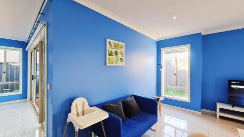 a blue living room with a blue wall at Blue Home by GoodLive in Morang