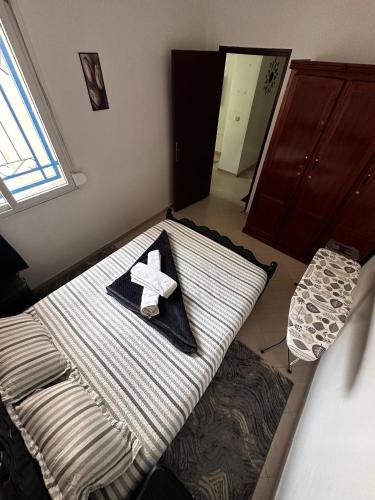 a bedroom with a bed with a star on it at Appartement Perle Agadir with WIFI in Agadir