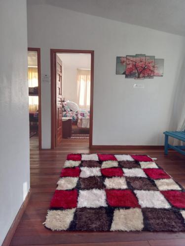 a living room with a rug on the floor at CASA MARTIN en Baños de Agua Santa in Baños