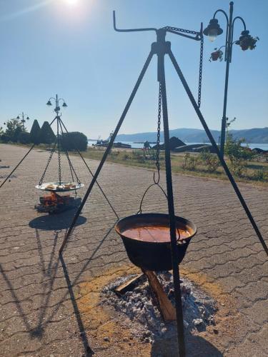 a bowl hanging from a pole with a fire at Vila Ljubomir - Srebrno Jezero in Kisiljevo