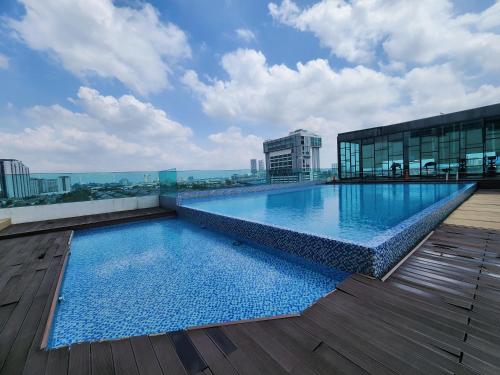 a large swimming pool on the roof of a building at Studio E Sofo Apartment Suria Jaya -Shah Alam in Shah Alam