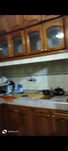 a blurry picture of a kitchen stove with wooden cabinets at Maison bouchra in Oulad Akkou
