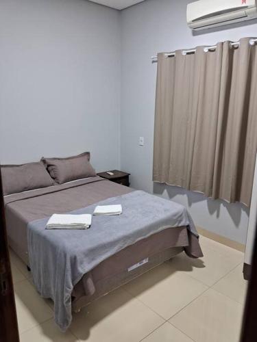 a bedroom with a bed with two towels on it at Residencial Málaga 02 in Sinop
