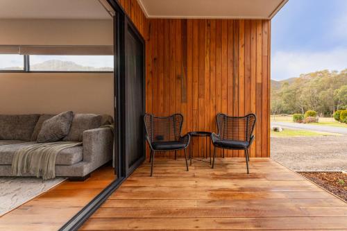 a living room with two chairs and a couch at Small Scale Stays - Couples Retreats in Halls Gap