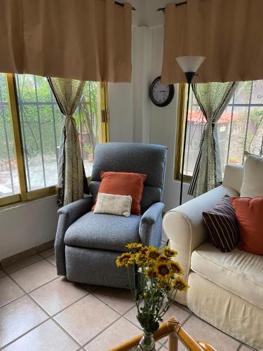 a living room with a couch and a chair at Quinta Ángeles in Cuernavaca