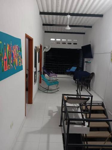 a hallway with chairs and tables in a room at Acogedor apartamento familiar in Mariquita