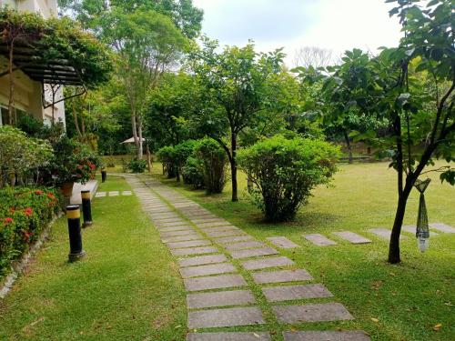 a stone path in a park with trees and bushes at Shuang Liou B&B in Mingjian