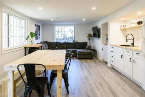 a kitchen and living room with a table and a couch at Spacious 2-BR Retreat Near Louisville Attractions in Louisville