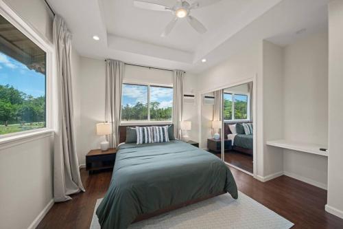 a bedroom with a bed and a large window at HAWAII PARADISE 3Bd2a Home w Pool and FirePit near Ocean in Keaau