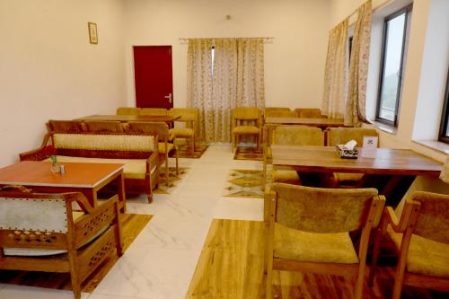 a dining room with tables and chairs and tablesktop at Wow Relish in Alwar