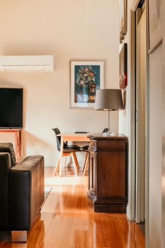 a living room with a table and a couch at Port Boutique Accommodation in Port Fairy