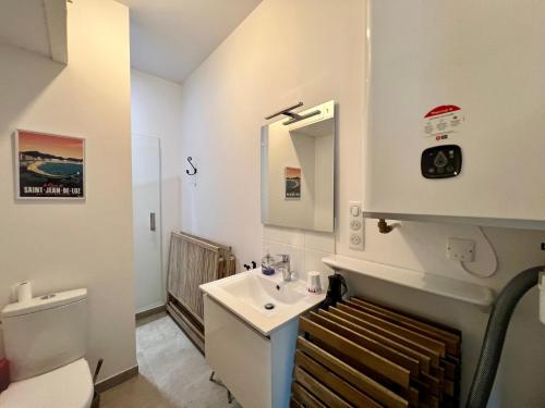 a white bathroom with a sink and a toilet at Maison de Vacances à Ciboure - Calme et Proche Commerces - FR-1-239-1086 in Ciboure