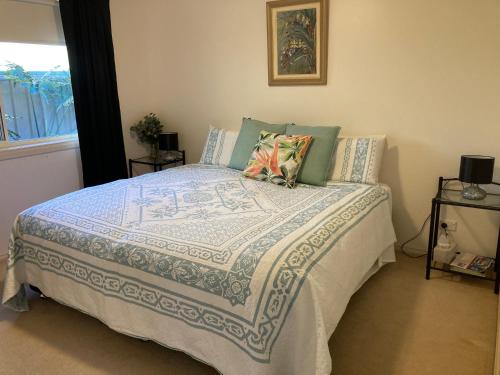 a bedroom with a bed with a blue and white comforter at HOME STAY on HIGH King Bed -- Private Home with Private Bathroom in Swan Hill