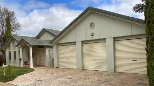 a house with two garage doors at HOME STAY on HIGH King Bed -- Private Home with Private Bathroom in Swan Hill
