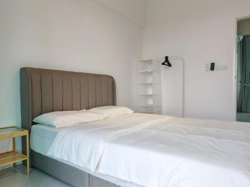 a bedroom with a large bed with white sheets at Meritus - Perai, Penang in Perai