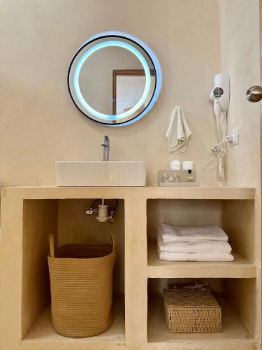 un baño con lavabo y espejo en Casa suite con Jacuzzi - Arenita Mia Suites, en Progreso
