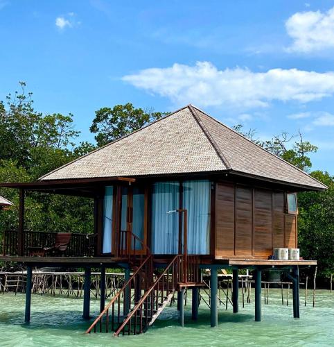 a house on a pier on the water at Leebong Island Resort in Leebong