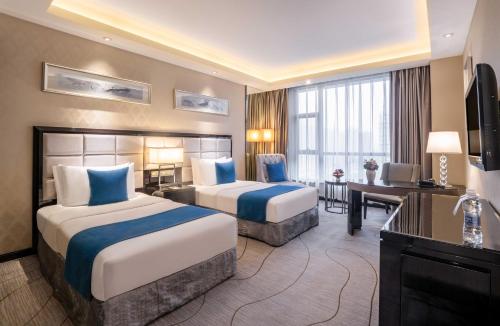 Postel nebo postele na pokoji v ubytování Zheng fang yuan international Hotel