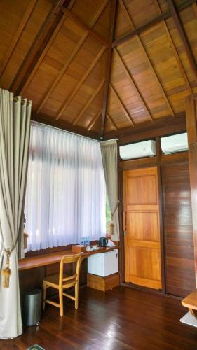 a home office with a desk and a window at Leebong Island Resort in Leebong