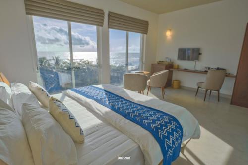 a bedroom with a bed with a view of the ocean at 50 By The Sea in Dehiwala
