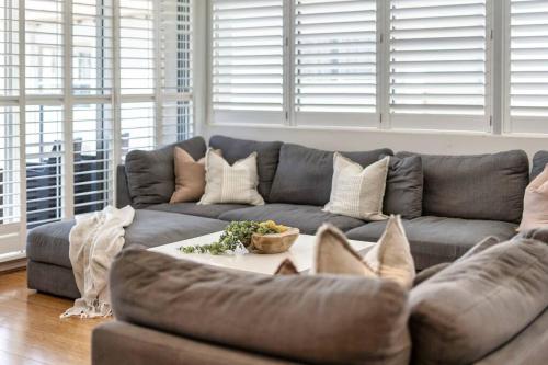 a living room with a couch and a table at Absolute Beachfront Apartment 3B Pool Spa in Gold Coast