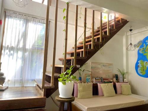 a living room with a couch and a staircase at Secret Spot Siargao in General Luna
