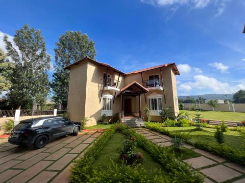 a car parked in front of a house at Wuthering Heights in Yelagiri
