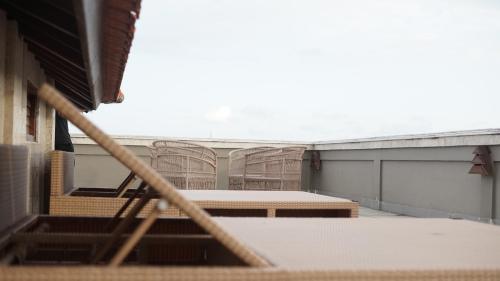 an empty room with a table and chairs in it at Alu Lofts in Seminyak
