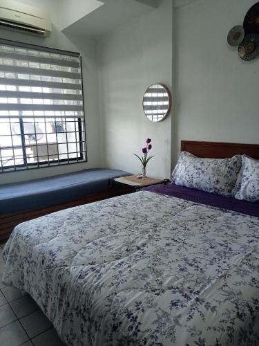 a bedroom with a large bed and a window at Homestay PD LESTARI 2 in Port Dickson