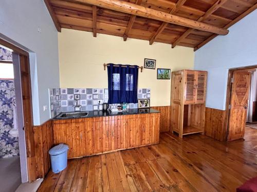 a kitchen with wooden floors and a counter top at Kasar Himalaya Holiday Resort, Binsar Rd in Almora