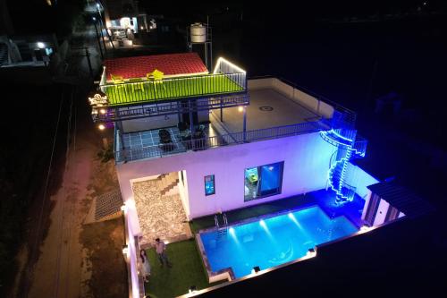 an overhead view of a house with a swimming pool at Sanwariya Villa with Hill view in Thūr
