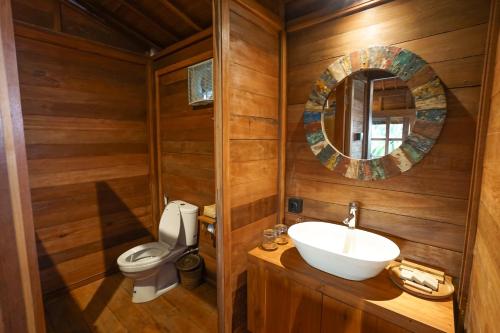 a bathroom with a sink and a toilet at Ubud Art Resort in Ubud