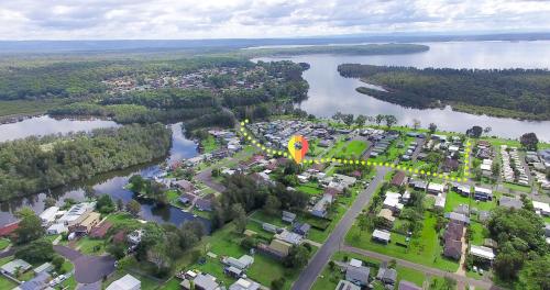 an aerial view of a park next to a body of water at Perfect for Two Families in Sussex inlet