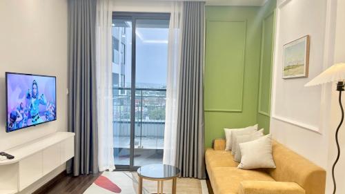 a living room with a couch and a window at LAD Apartment & Homestay Hải Phòng - Hoàng Huy Grand Tower in Hai Phong