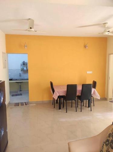 a dining room with a table and chairs at Sabri serinity apartment-Peepul 802 Siruseri in Siruseri