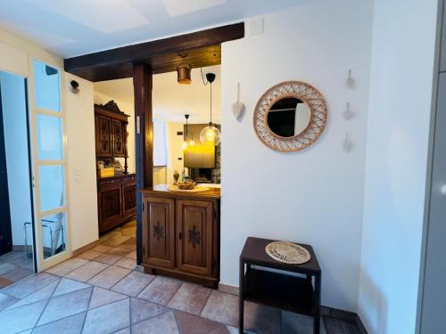 a kitchen with a table and a mirror on the wall at Casa Leoni a Moghegno in Moghegno