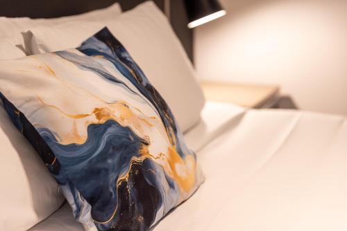 a pillow sitting on top of a bed at 315 Euro Motel and Serviced Apartments in Dunedin