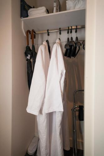 two white towels hanging on a rack in a closet at 315 Euro Motel and Serviced Apartments in Dunedin