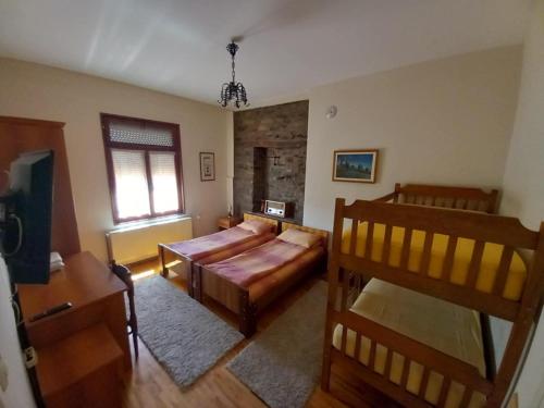 een woonkamer met een bank en een bed bij **ETNO Vila** - KRUSEVO in Kruševo
